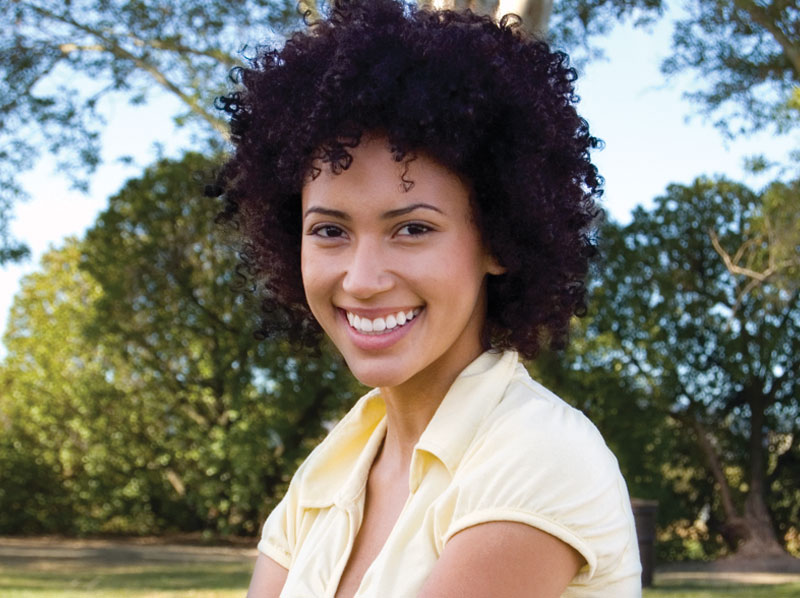 A lady smiling outside.